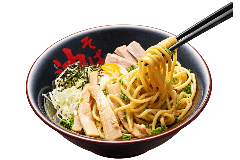 Chopsticks lifting thick noodles from a Tokyo Aburagumi Sohonten bowl of abura soba.