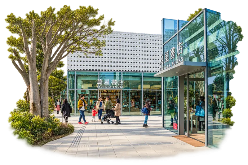 The patterned facade of Daikanyama T-SITE beside a tree-lined walkway.