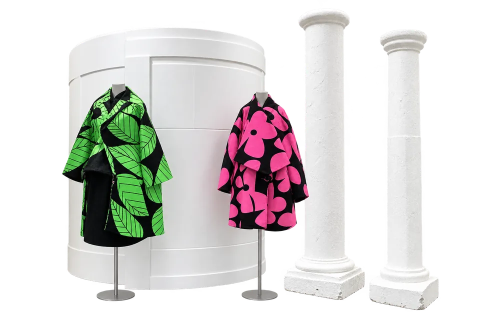 Green and pink coats with sculptural white columns, adapted from DSMG’s display.